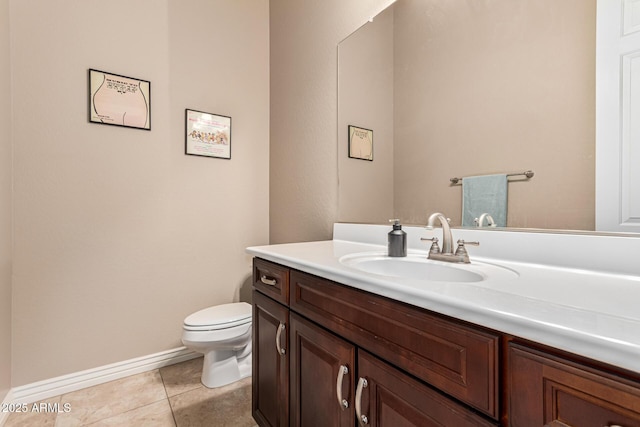 bathroom featuring tile patterned flooring, vanity, and toilet