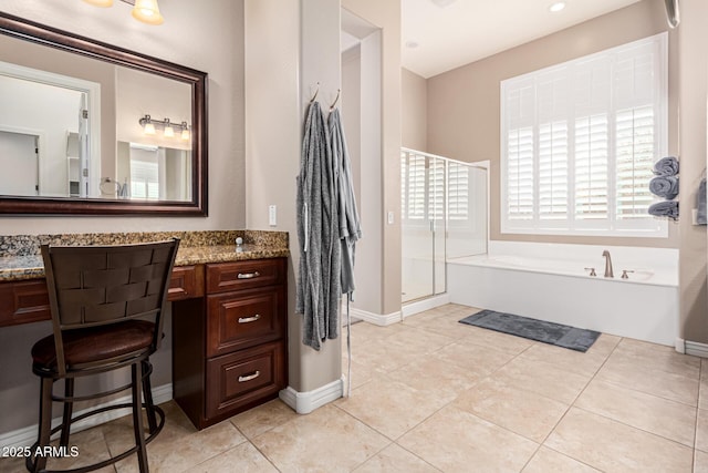 bathroom with shower with separate bathtub, vanity, and tile patterned floors