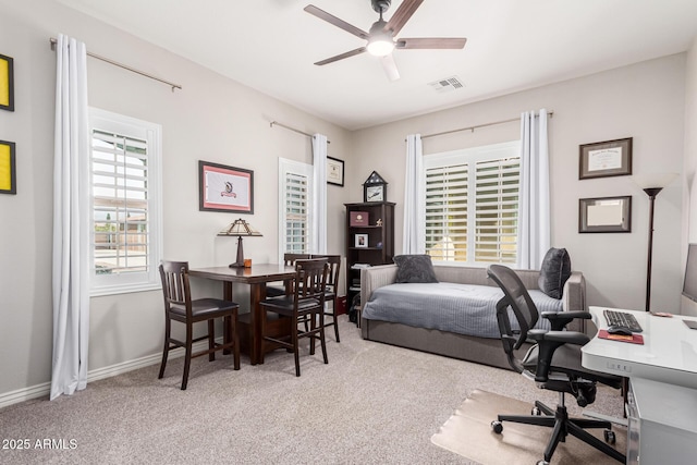 carpeted home office with ceiling fan