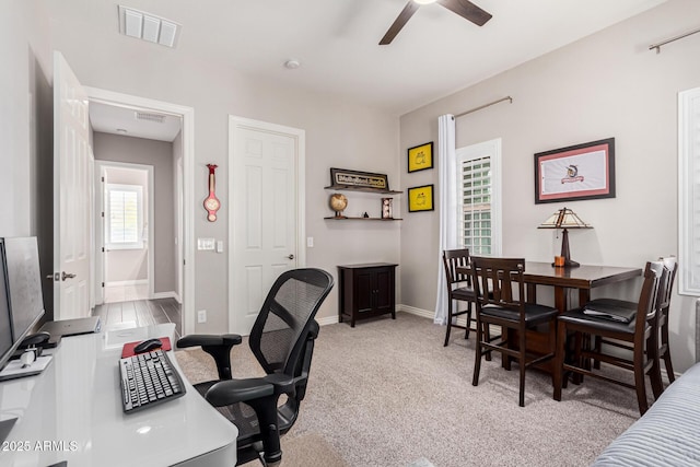 office featuring ceiling fan and light carpet