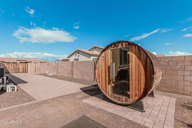 view of patio with a storage shed