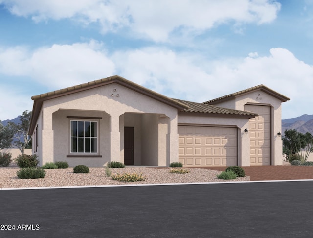 mediterranean / spanish-style house featuring a garage and a mountain view