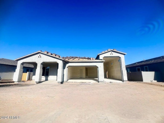 mediterranean / spanish-style home with a patio area