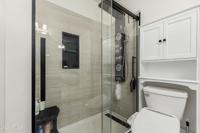 full bathroom featuring toilet and a stall shower