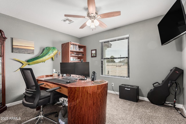 carpeted home office with baseboards, visible vents, and a ceiling fan