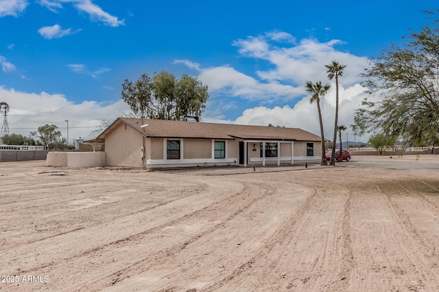ranch-style house with fence