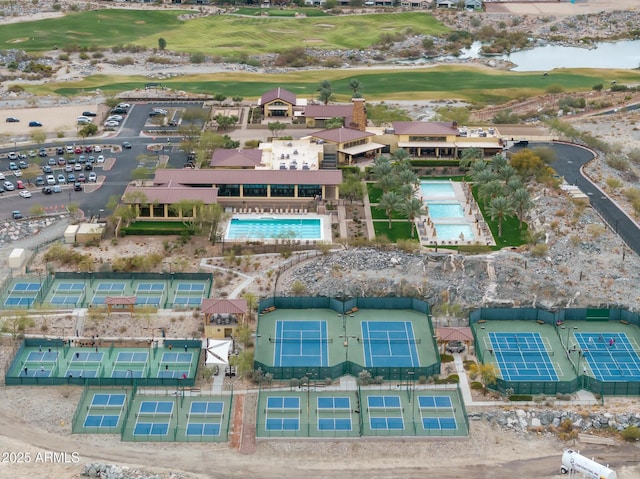 drone / aerial view with view of golf course and a water view