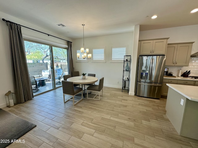 dining room featuring recessed lighting, visible vents, baseboards, light wood-style flooring, and a notable chandelier