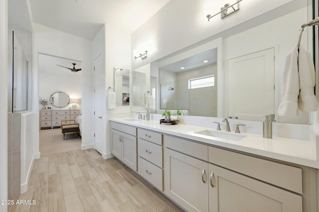 bathroom with a sink, double vanity, wood finished floors, ensuite bath, and a walk in shower