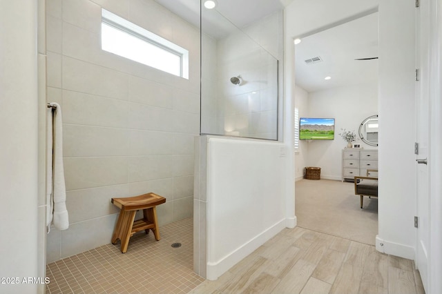 full bathroom with wood finished floors, visible vents, and a walk in shower
