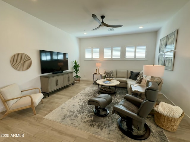 living area with recessed lighting, light wood-type flooring, baseboards, and ceiling fan