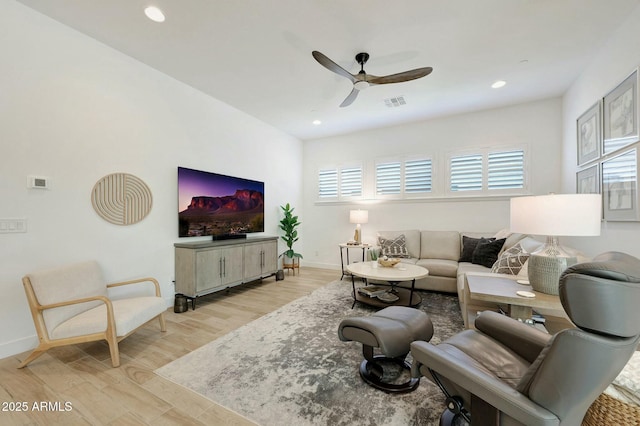 living area featuring a ceiling fan, light wood finished floors, baseboards, visible vents, and recessed lighting