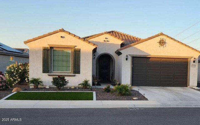 27636 W Runion Dr, Buckeye, AZ 85396 - mediterranean / spanish home featuring stucco siding, an attached garage, driveway, and a tiled roof