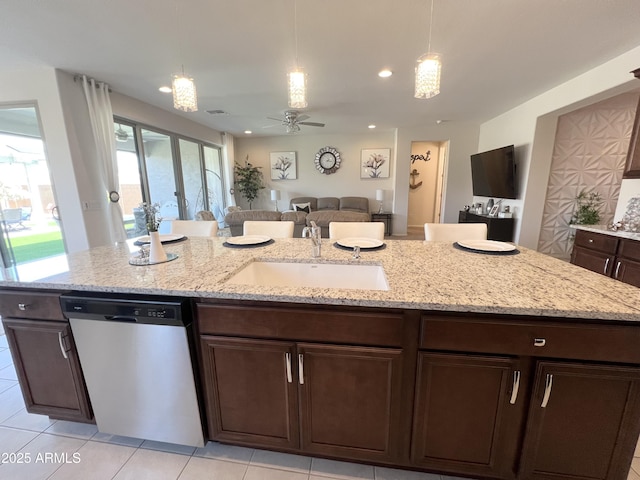 27636 W Runion Dr, Buckeye, AZ 85396 - kitchen with dishwasher, a sink, a ceiling fan, dark brown cabinets, and hanging light fixtures
