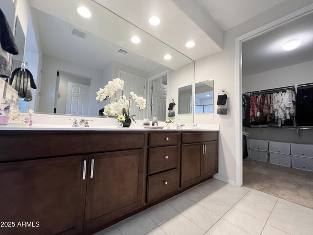 27636 W Runion Dr, Buckeye, AZ 85396 - full bathroom with tile patterned flooring, double vanity, a walk in closet, recessed lighting, and baseboards