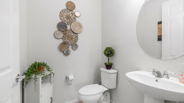 27636 W Runion Dr, Buckeye, AZ 85396 - half bathroom with a sink, baseboards, and toilet