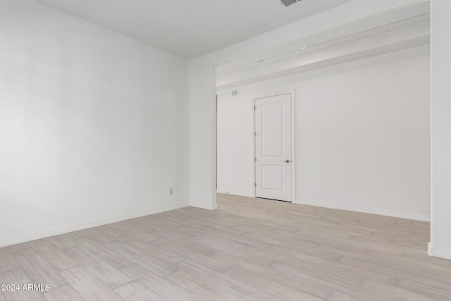 spare room featuring light hardwood / wood-style floors