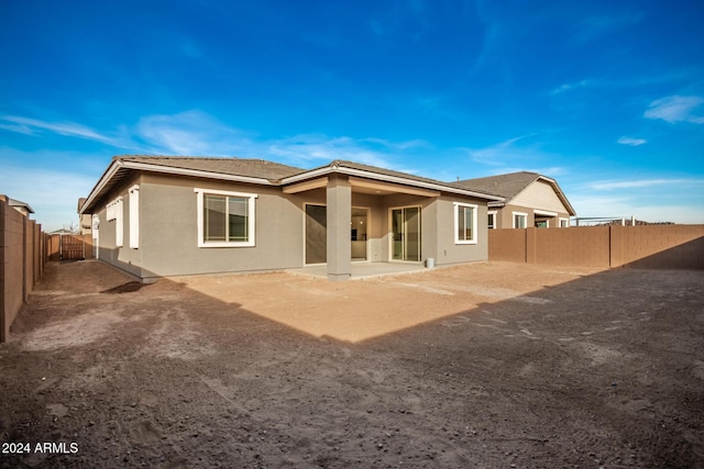 back of property with a patio