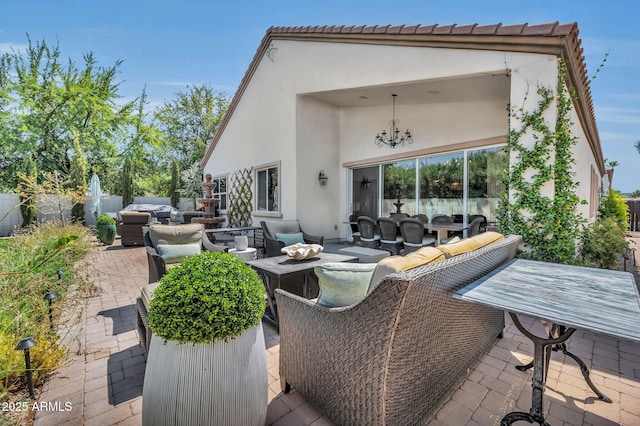 view of patio with an outdoor hangout area, outdoor dining area, and fence