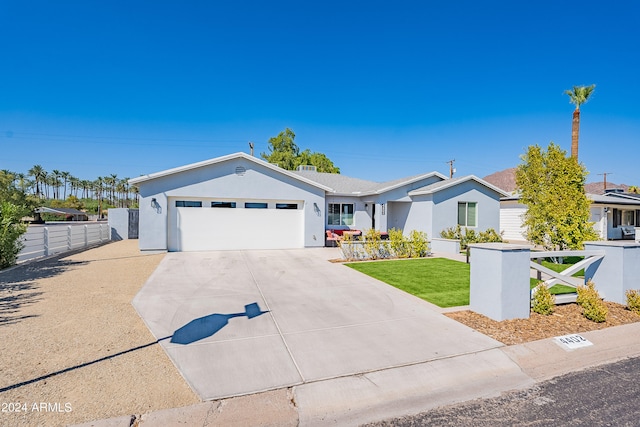 ranch-style home featuring a garage and a front lawn