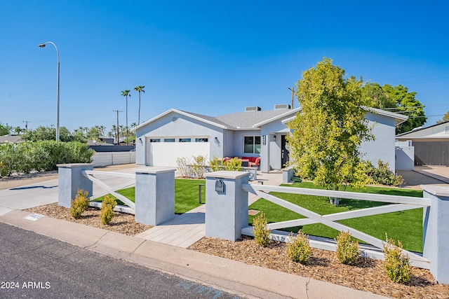 view of front of home featuring a garage and a front lawn