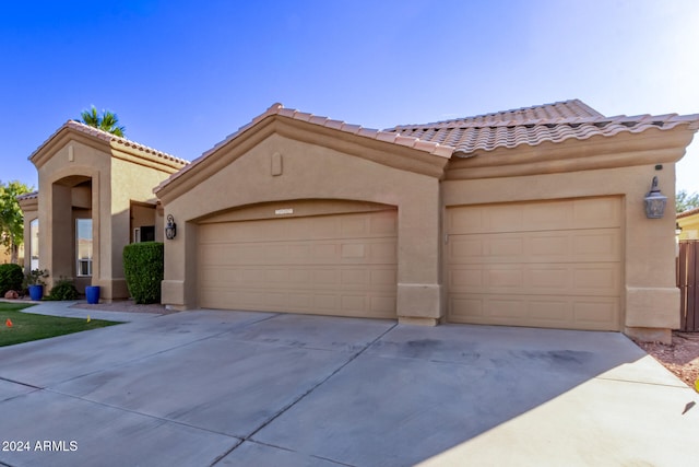 mediterranean / spanish-style home featuring a garage