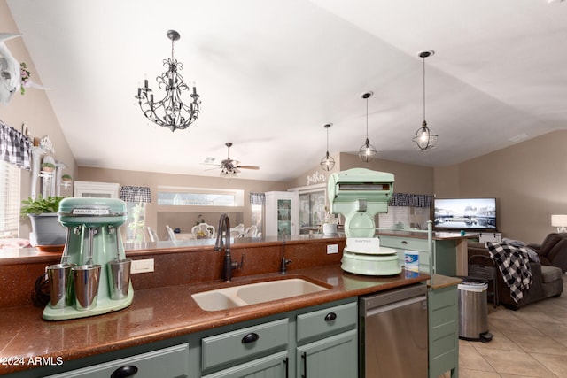 kitchen with decorative light fixtures, vaulted ceiling, stainless steel dishwasher, and sink