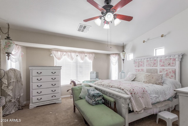 carpeted bedroom featuring multiple windows, lofted ceiling, and ceiling fan