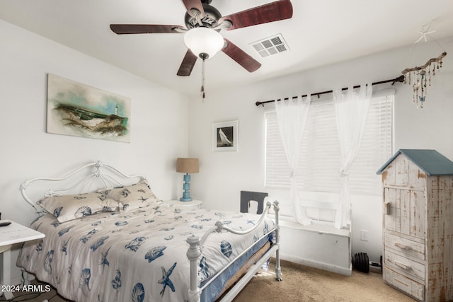 bedroom with ceiling fan and light carpet