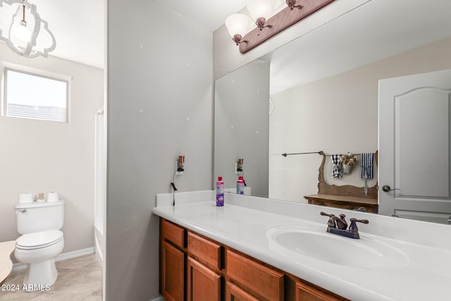 bathroom featuring tile patterned flooring, vanity, and toilet