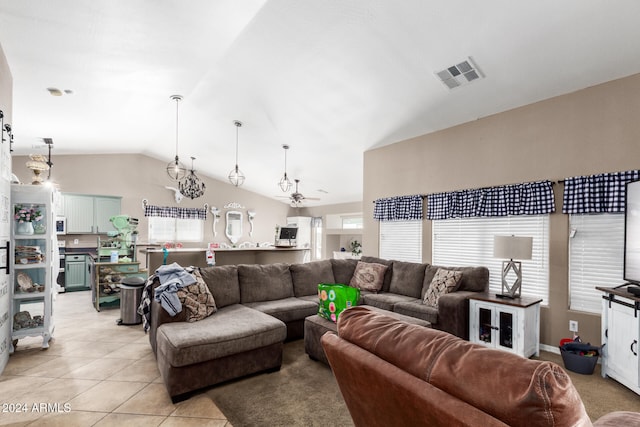 tiled living room with ceiling fan and vaulted ceiling