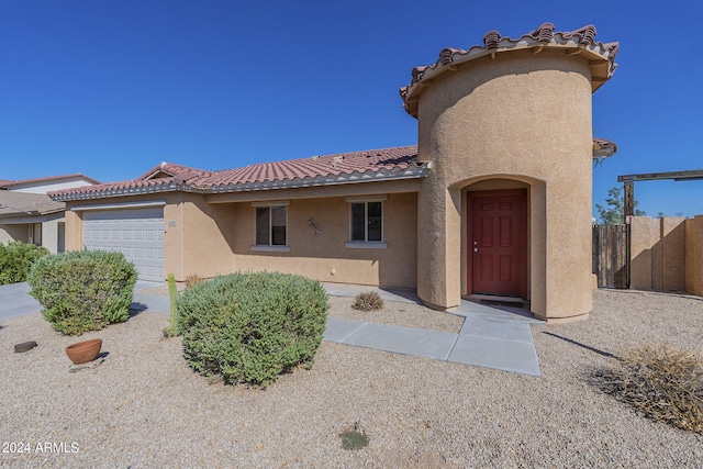 rear view of property with a garage