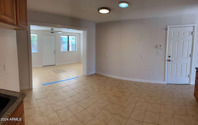 entrance foyer with ceiling fan and light tile patterned floors