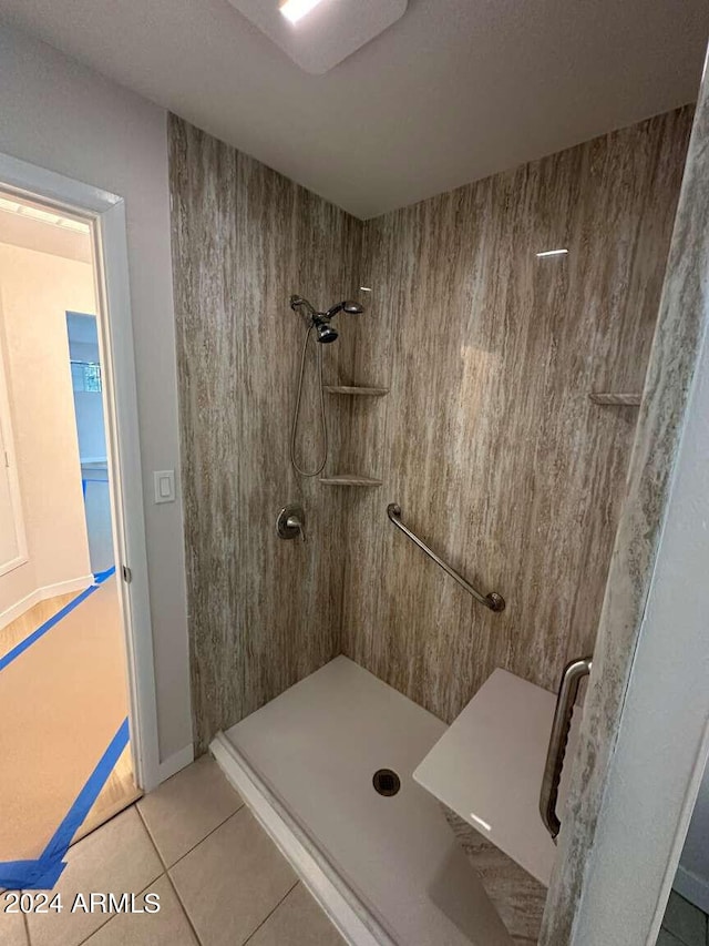 bathroom featuring tile patterned floors and tiled shower