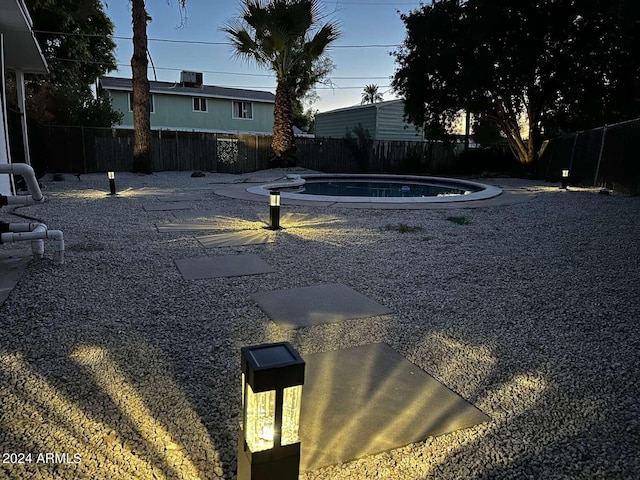 view of yard with a patio and an empty pool