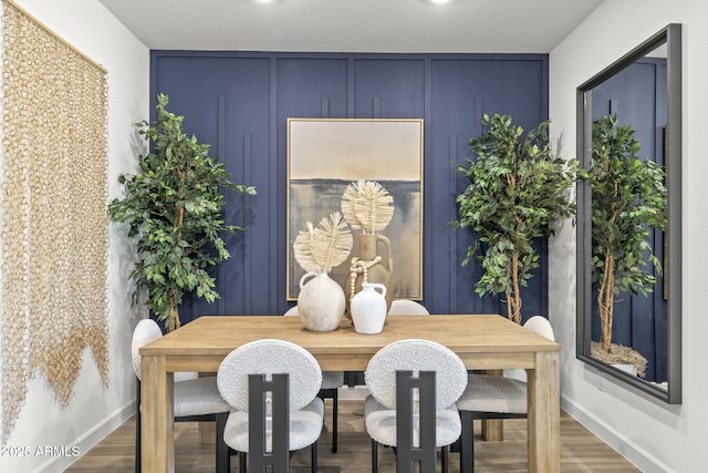 dining area with wood finished floors and baseboards