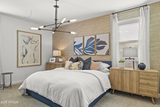 bedroom with baseboards, carpet, and a notable chandelier