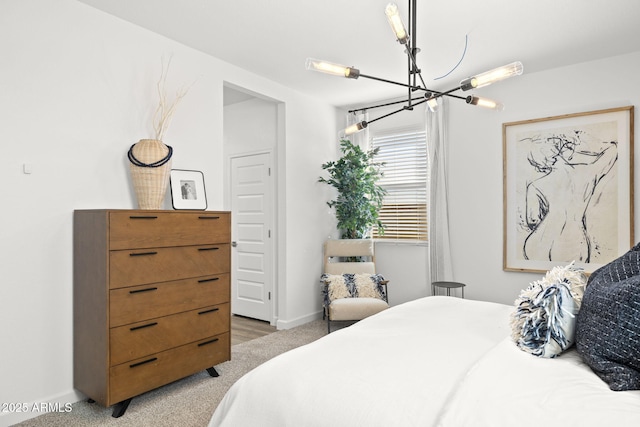 bedroom with a chandelier, light carpet, and baseboards