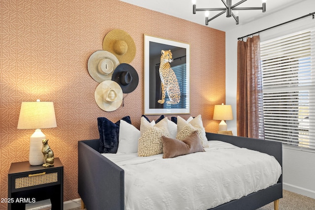 bedroom with a notable chandelier, multiple windows, baseboards, and wallpapered walls