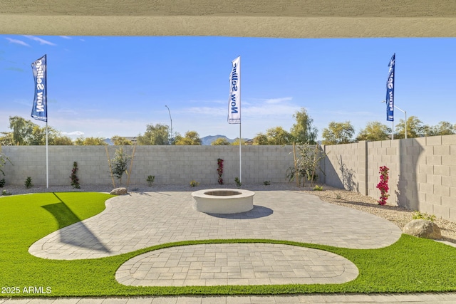 view of patio / terrace featuring a fenced backyard and a fire pit