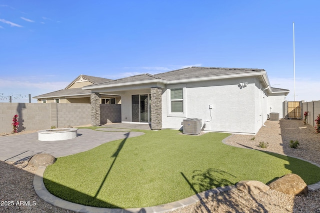 back of property featuring a patio area, a fire pit, central AC unit, and a fenced backyard