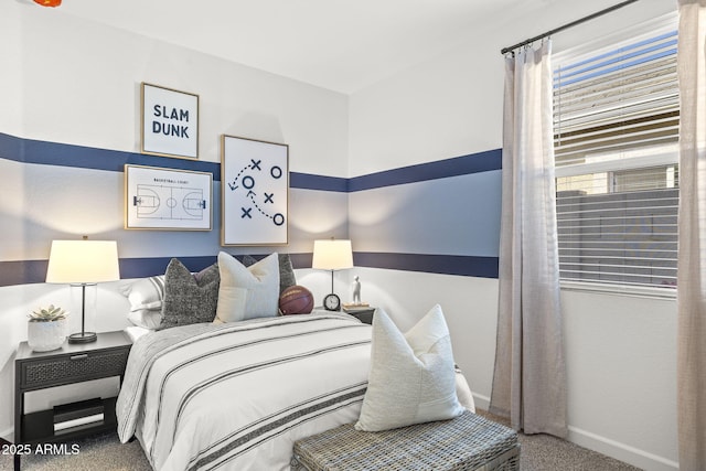 bedroom featuring carpet and baseboards