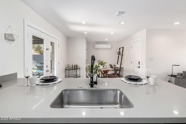 kitchen with sink, a wall mounted air conditioner, and french doors