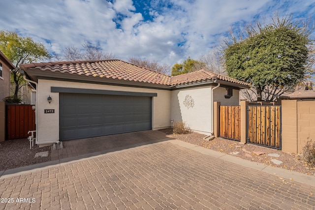 mediterranean / spanish-style house with a garage