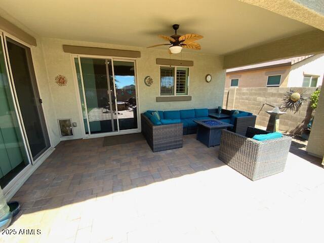 8587 N 171st Dr, Waddell, AZ 85355 - view of patio / terrace with an outdoor living space with a fire pit and a ceiling fan