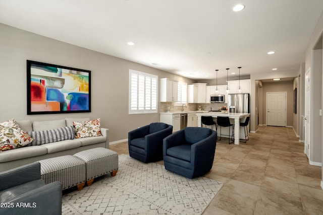 living area featuring baseboards and recessed lighting
