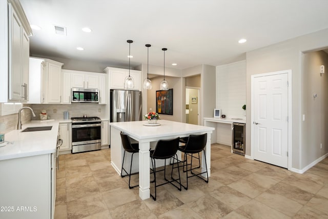 kitchen with tasteful backsplash, a center island, a sink, a kitchen breakfast bar, and stainless steel appliances