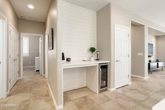 hallway with beverage cooler and baseboards