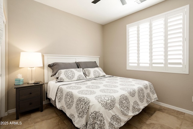 bedroom with visible vents, baseboards, and ceiling fan