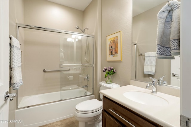 bathroom with tile patterned flooring, toilet, vanity, and enclosed tub / shower combo